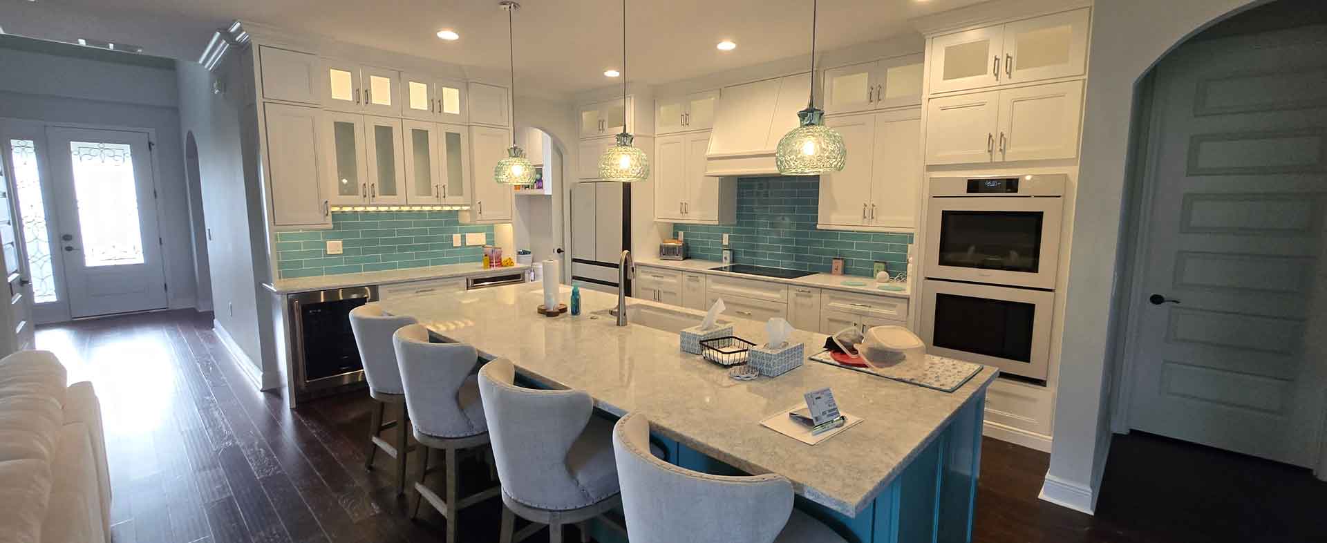 Newly remodeled kitchen with granite countertops and blue tile backplash by Dream Space Renovation LLC