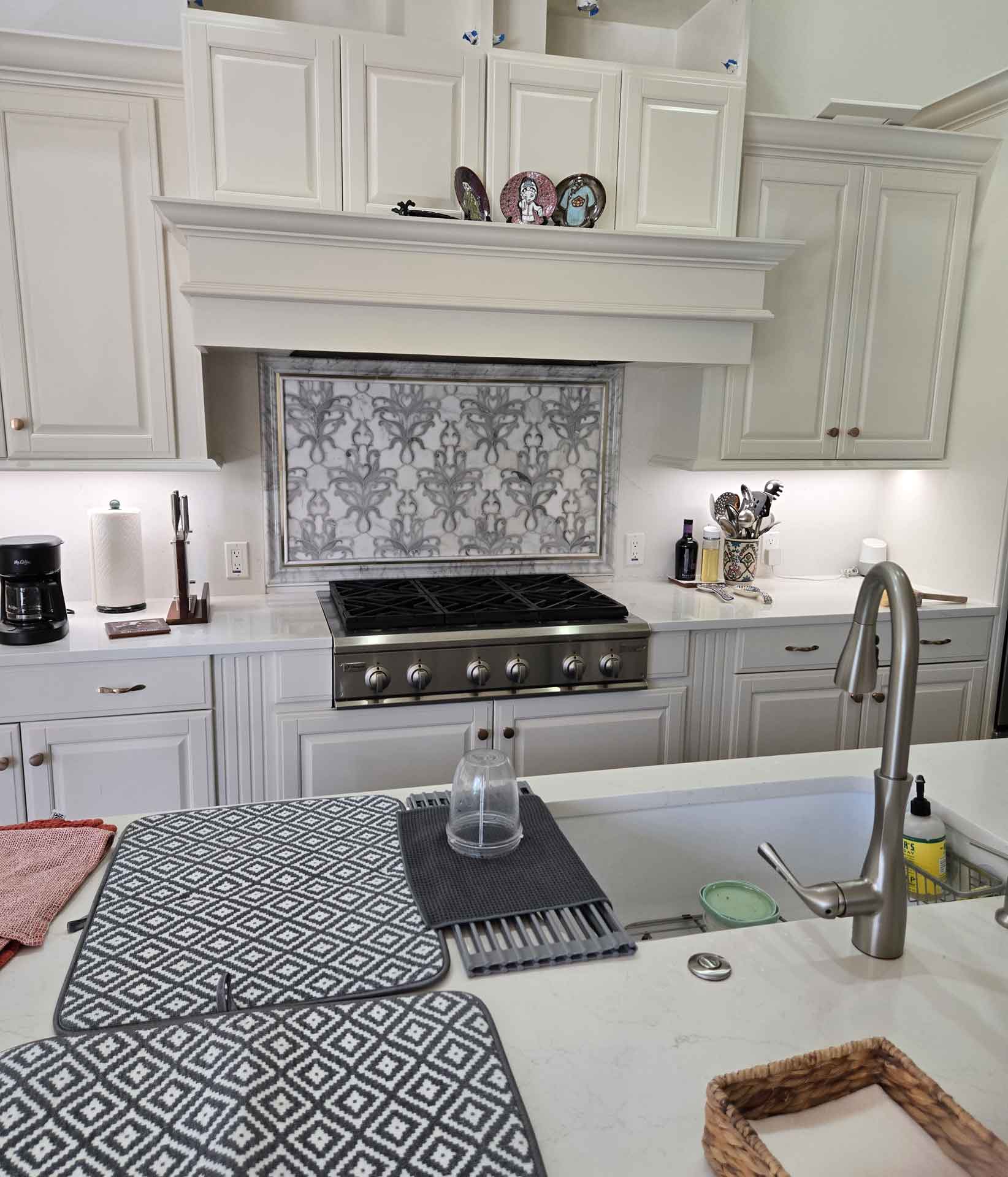 Gas stove with marble backsplash installed by Dream Space Renovation LLC